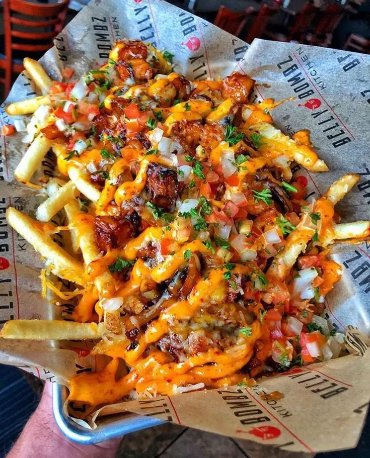 Crispy golden fries loaded with melted cheese, creamy sauces, and toppings, served hot as a delicious evening snack
